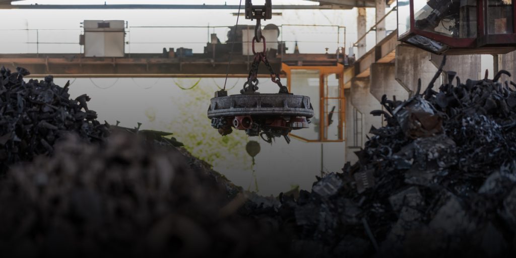 magnet picking up magnetic scrap metal